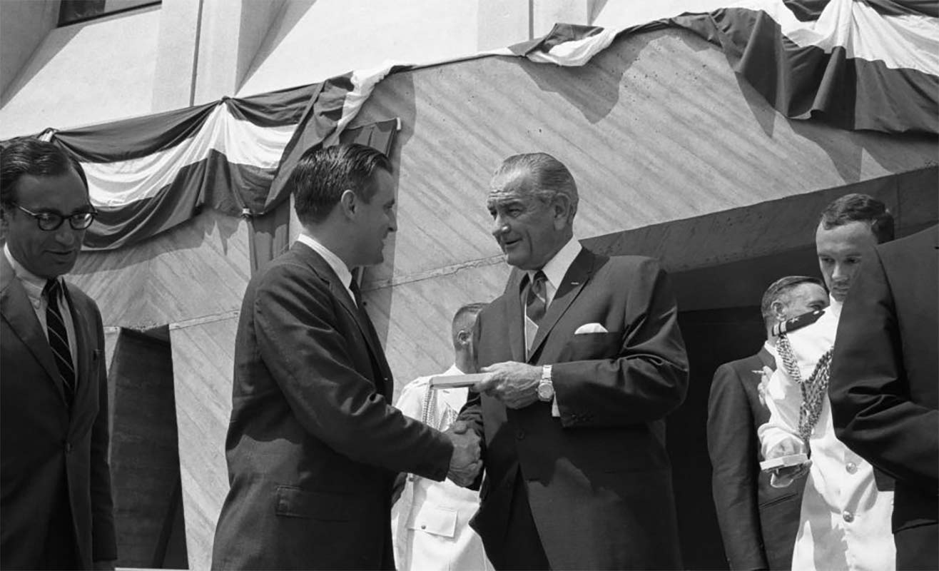 LBJ shaking hands at the announcement of the civil rights act of 1968